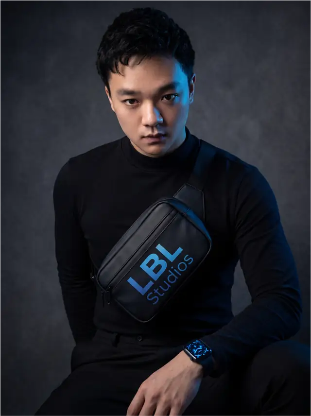 Justin Won wearing a cross-body sling with a blue-faced watch